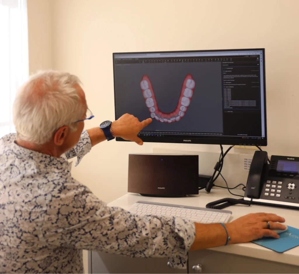 Orthodontist reviewing a 3D digital scan of a patient's teeth
