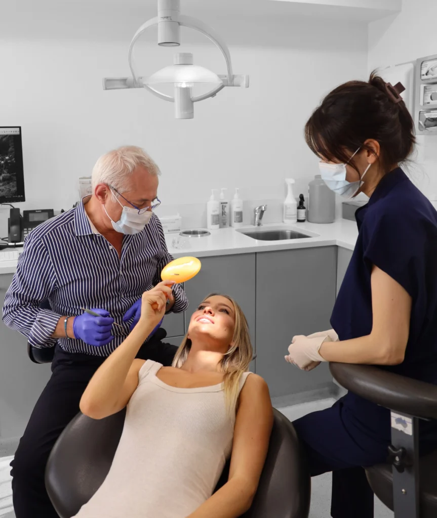 An orthodontist assessing a patient before fitting an oral appliance